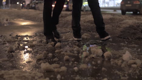 two people walking in the winter city at night