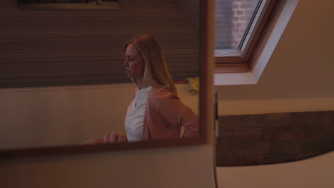 woman reflected in a mirror in a bedroom