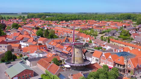 aerial over classic dutch holland town with prominent windmill sluis netherlands 2