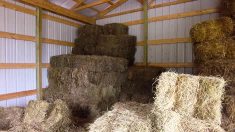 Stacking-bale's-of-hay-in-metal-barn