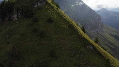 Epic-aerial-shot-flying-upwards-and-forward,-revealing-the-ridge-of-the-sharp-slopes-that-is-Morgenberghorn-in-Switzerland