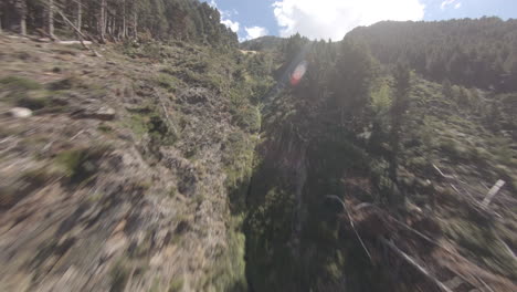 epic fpv drone shot flying up mountain over trees and canyons in puymorens