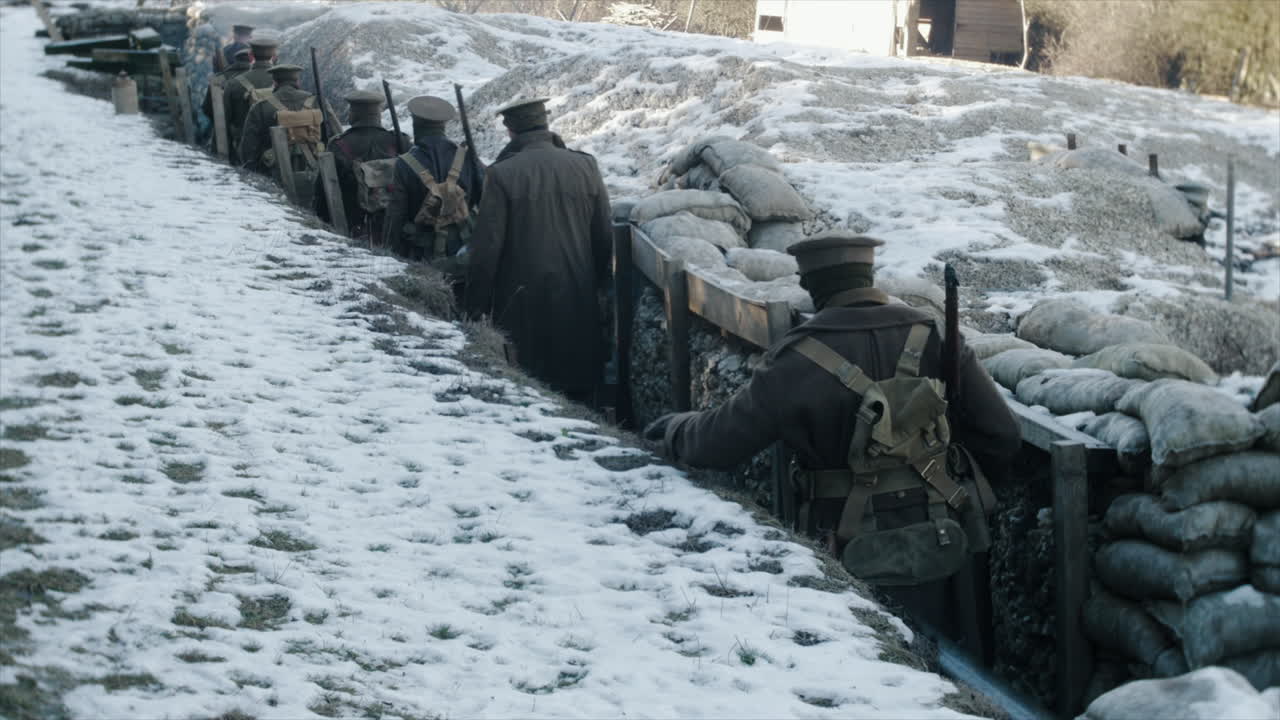 World War One British soldiers walk through a trench towards the front line