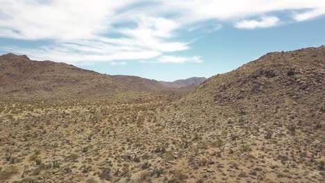 Aerial-flyover-Joshua-Tree-National-Park-during-sunny-day-and-clouds