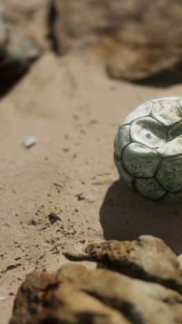 old soccer ball on the beach