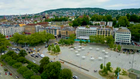 4k drone video of the sechseläutenplatz town square on the limmat river in downtown zurich, switzerland