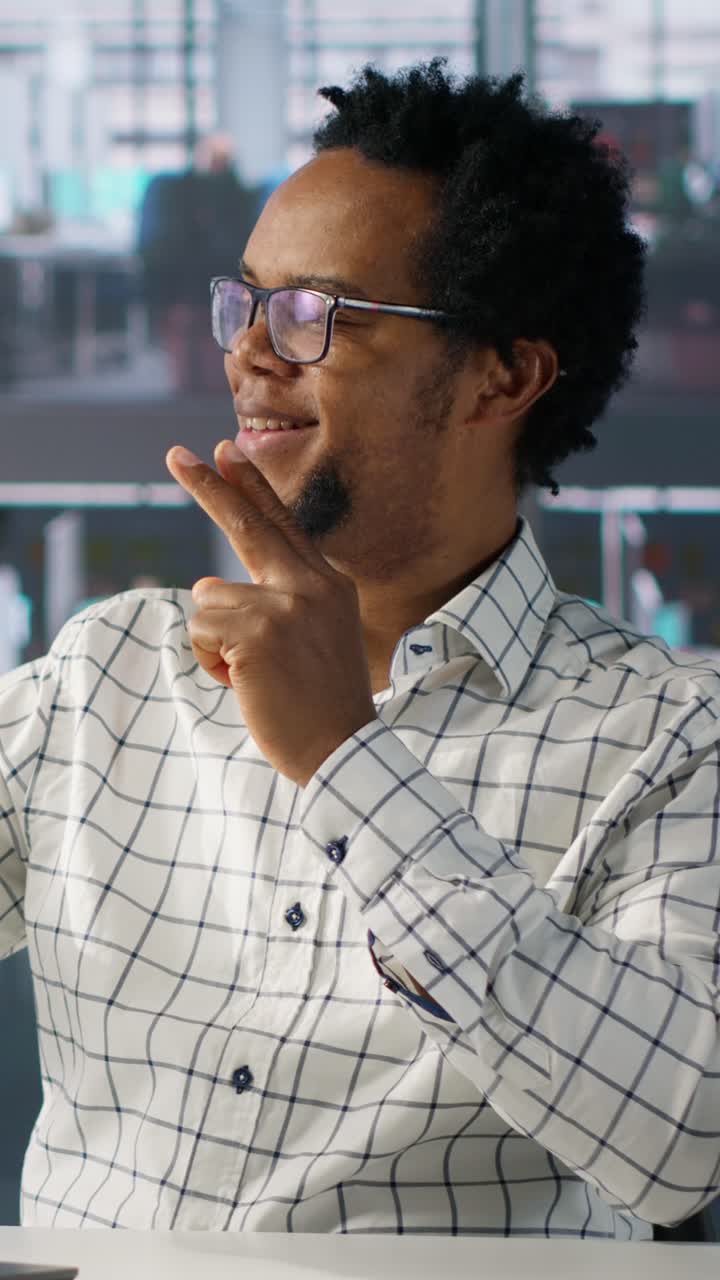 Thoughtful African American Businessman Listening and Gesturing in Office