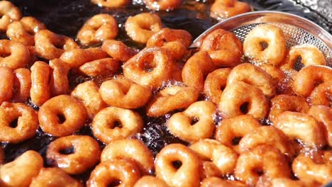 close-up of doughnuts frying in oil