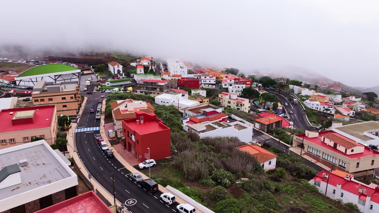 A dense morning cloud blankets Villa de Valverde, creating a dreamy island scene