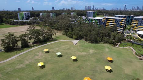 aerial view of a park with buildings and city skyline in the background