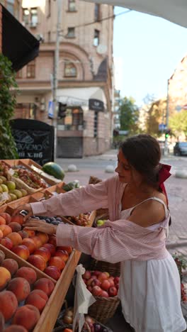 woman shopping for fruits at a street market