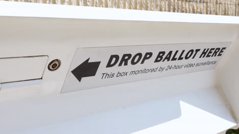 drop ballot here sign and slot with arrow for mail-in election early voting box