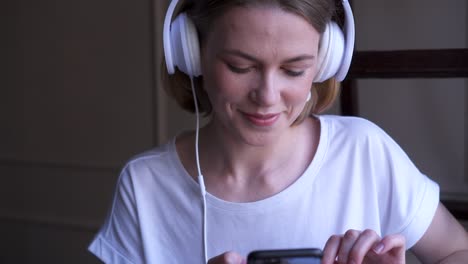 stylish girl in headphones posing at camera