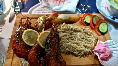 wooden table with delicious red shrimps with thai rice. close up