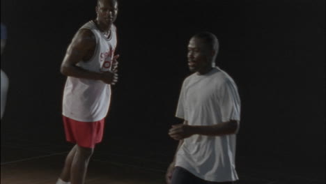 men passing a basketball around on a court