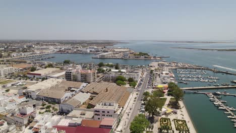 Aerial-of-Olhão,-Algarve-Portugal,-featuring-marina,-buildings-and-the-waterfront