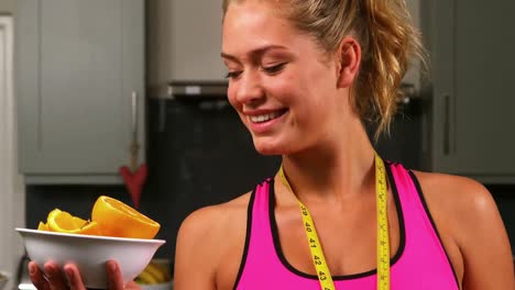 pretty blonde holding plate of oranges