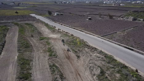 Aerial-shot-moving-sideways-following-motocross-riders-as-they-hit-a-jump