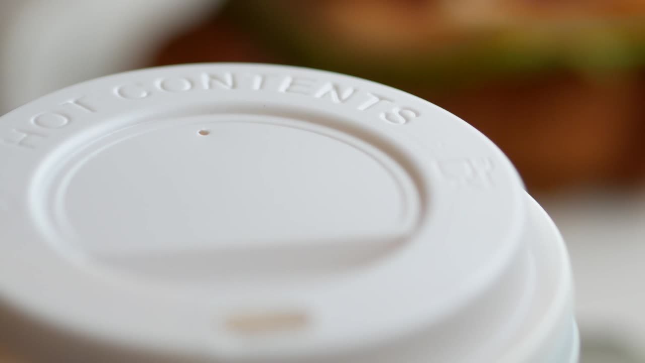 Close-up of a disposable coffee cup lid