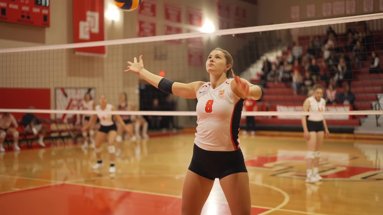 Female Volleyball Player Serving During a Match