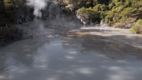 aerial push-out shot above the boiling mud pools at waiotapu, rotorua, new zealand