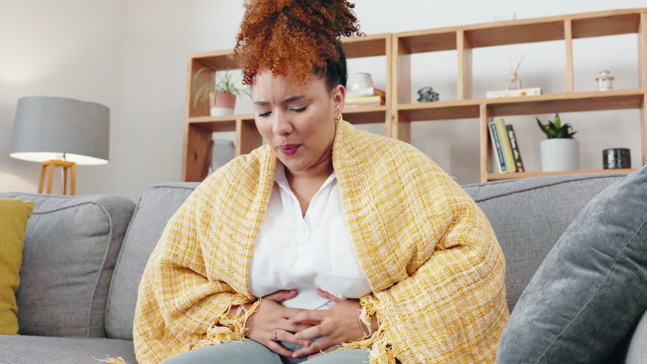 Sick black woman, stomach and body pain in house