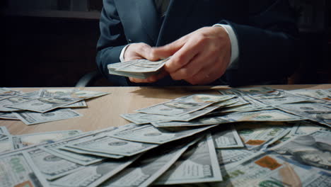 closeup accountant calculating cash putting banknotes on table. counting bills.