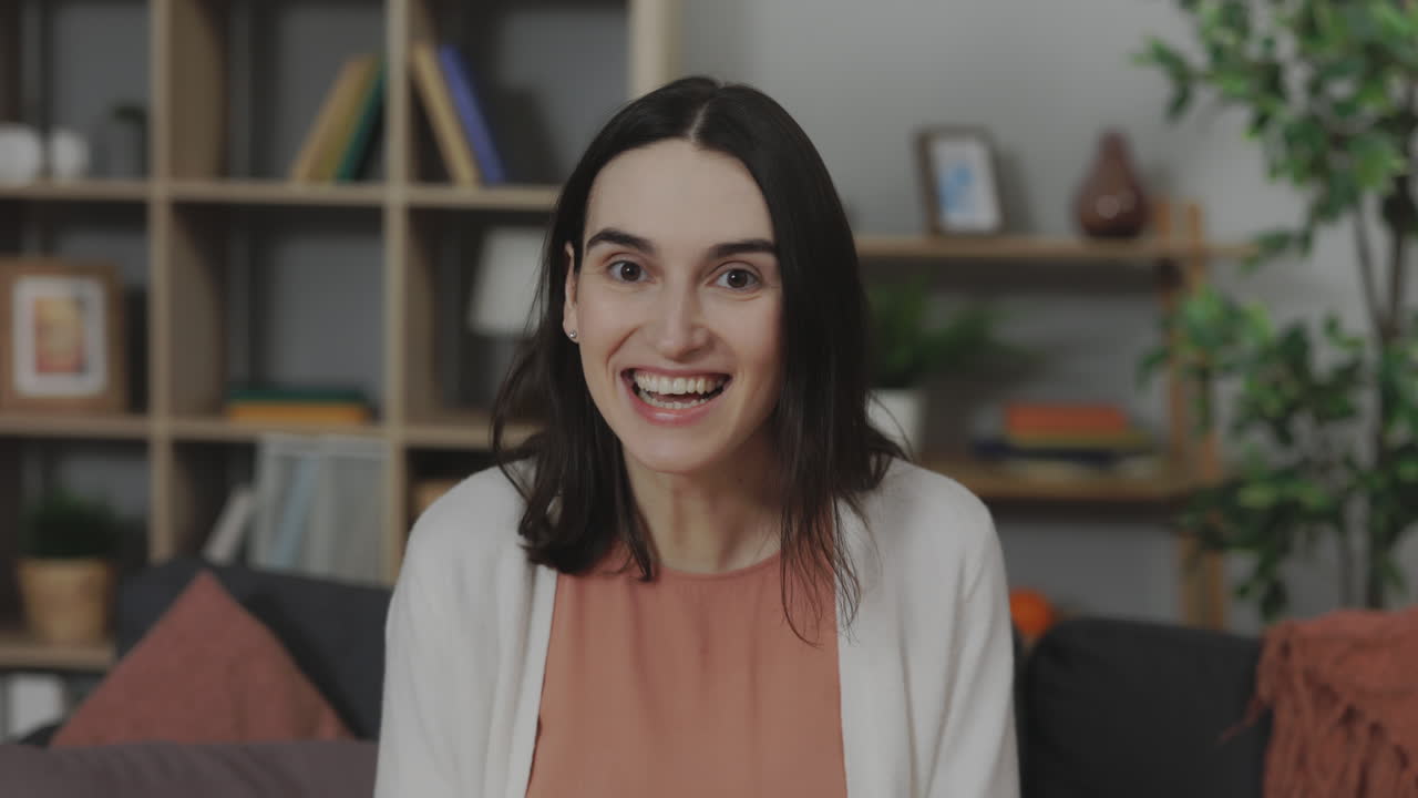 Happy Woman Smiling at Camera in Living Room