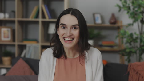 happy woman smiling at camera in living room