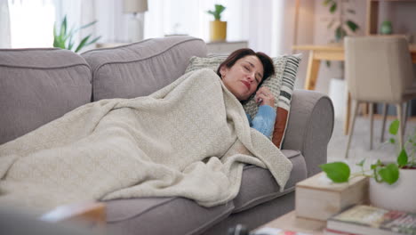 sick woman resting on a couch