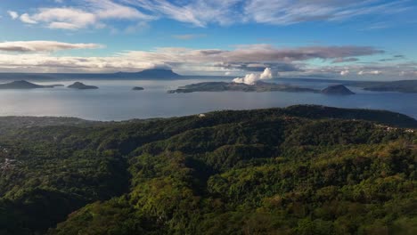 cinematic drone shot of green hilly landscape with bay in philippines