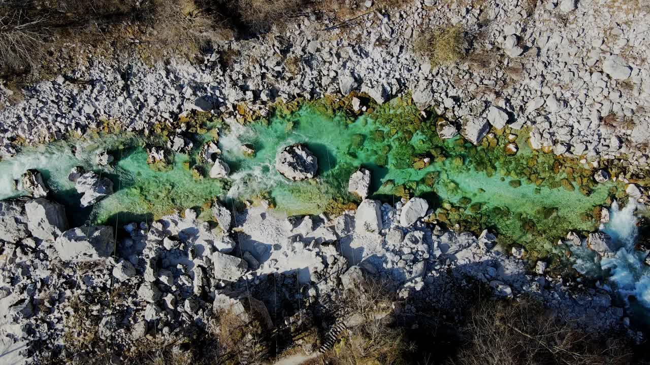 Soča River flowing through Slovenian Alps, crystal-clear waters, rocky, spring
