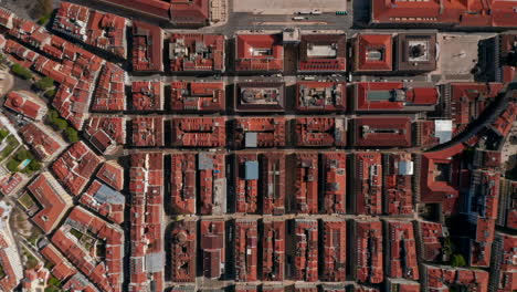 Aerial-birds-eye-overhead-top-down-panning-view-of-streets-and-buildings-in-town.-Symmetrical-deployment-of-house-blocks-from-above.-Lisbon,-capital-of-Portugal.