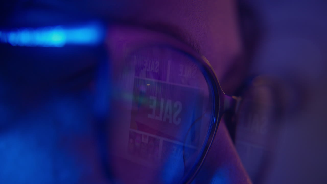 Close-up of Person's Eye with Online Sale Reflected in Glasses