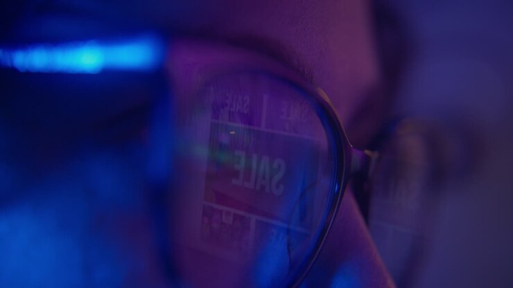 Close-up of Person's Eye with Online Sale Reflected in Glasses