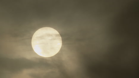 sun partially obscured by clouds