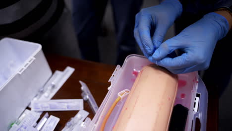 training operation on a mannequin, closeup video. medical training. surgery operation on medical dummy.