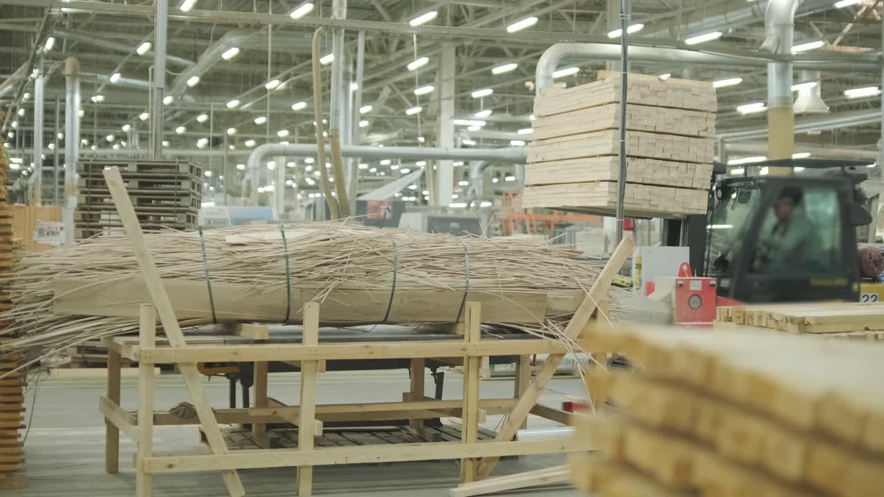 Forklift Moving Stack of Wooden Planks in a Wood Processing Factory