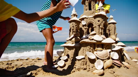 niños construyendo castillos de arena en la playa
