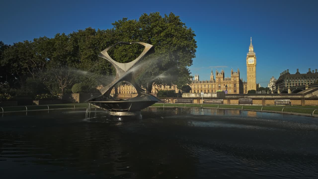 The fountain is called Revolving Torsion and was created by Naum Gabo under commission from the Tate Gallery. In the background is Big Ben and Houses of Parliament at sunrise, London, UK.