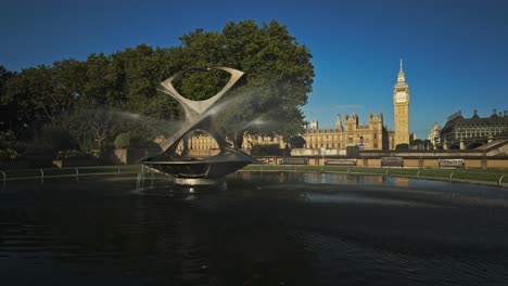 the fountain is called revolving torsion and was created by naum gabo under commission from the tate gallery. in the background is big ben and houses of parliament at sunrise, london, uk.