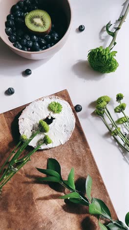 breakfast arrangement with berries, kiwi, and flowers