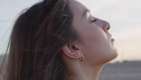 close up side profile young white skin woman breathing and relaxed during sunset or sunrise