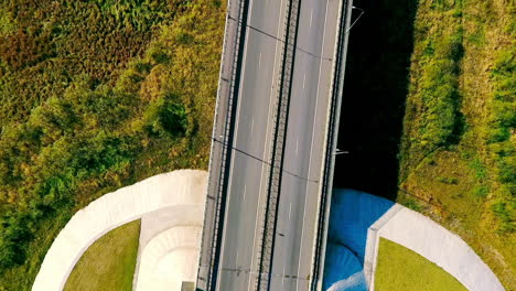 Aerial-view-highway-road-in-green-field.-Cars-driving-on-suburban-road