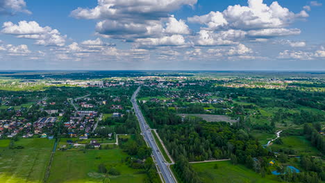 aerial hyperlapse of town and countryside seen from above under cloudy sky