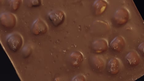 Black-chocolate-block-bar-in-woman's-hand-close-up