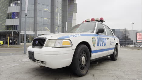 nypd police car in front of a shopping mall