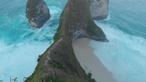 Monkeys-chilling-at-kellingking-beach-nusa-penida-Indonesia,-aerial