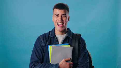 smiling student with books and backpack