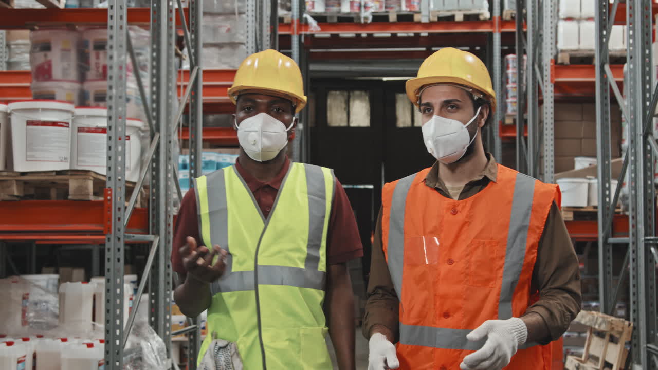 Warehouse Workers in Face Masks Walking and Talking